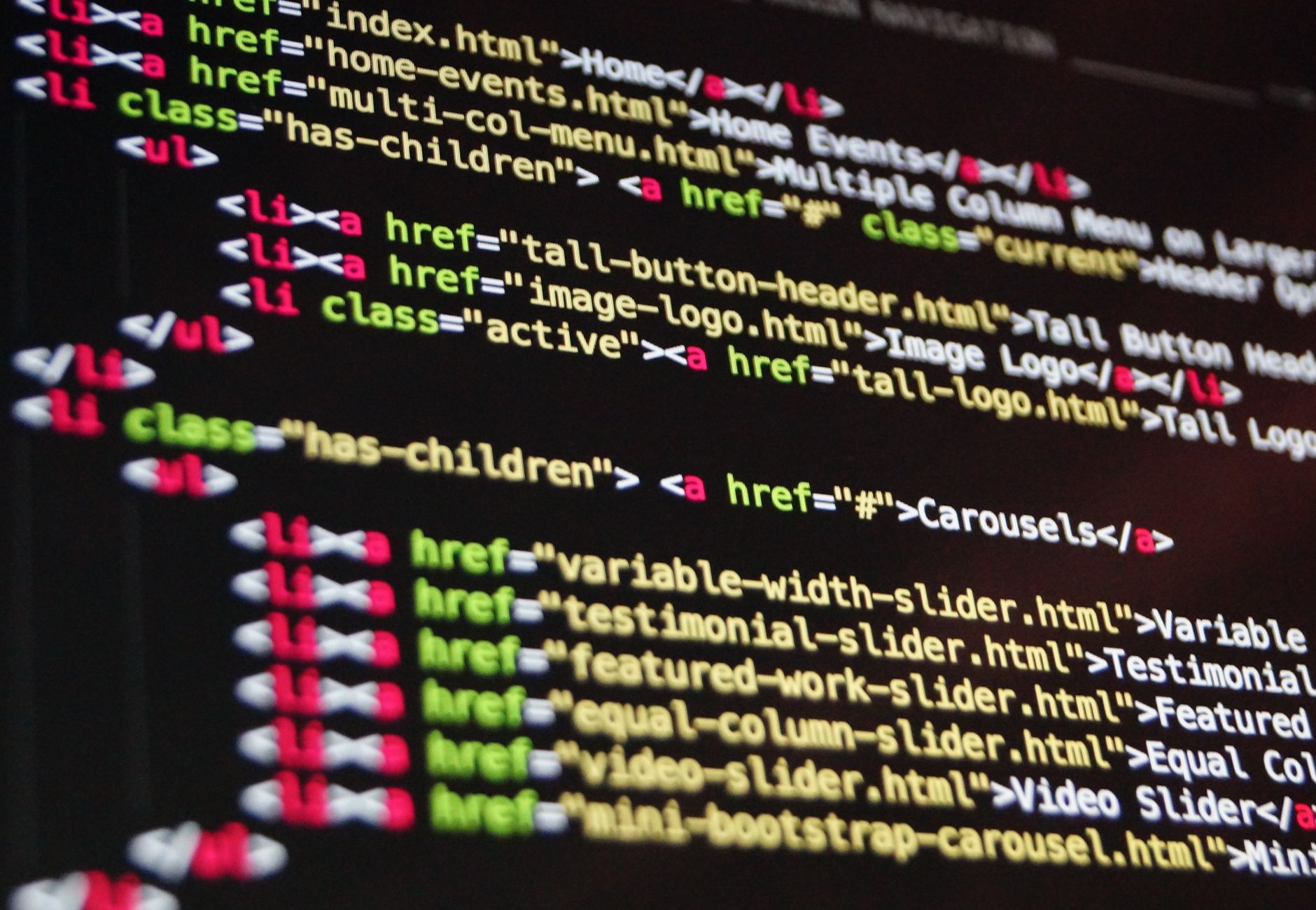 Close-up of HTML code highlighted in vibrant colors on a computer monitor.